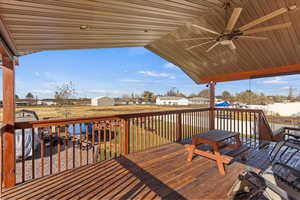 Wooden deck featuring ceiling fan