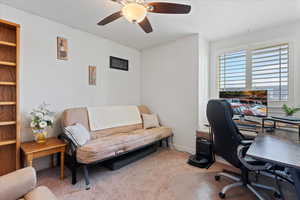 Office space featuring ceiling fan and carpet