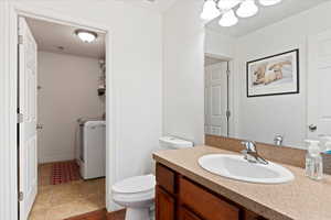 Bathroom with hardwood / wood-style floors, vanity, and toilet