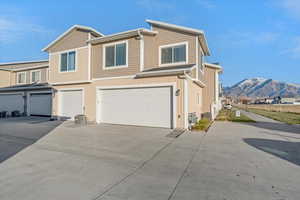 View of back of property with a mountain view and a 2 car garage