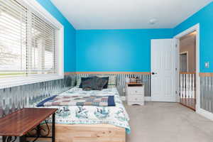 Bedroom featuring light colored carpet