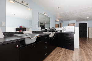 Bathroom with vanity, a textured ceiling, and hardwood / wood-style flooring