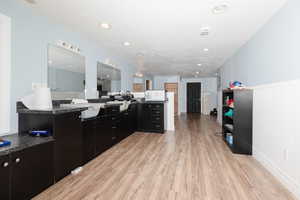 Kitchen featuring a textured ceiling and light hardwood / wood-style floors