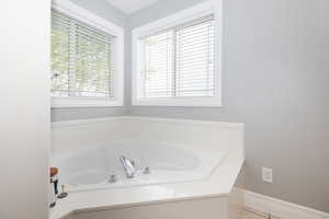 Bathroom with tile patterned floors and a bathtub