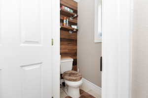 Bathroom with tile patterned flooring and toilet