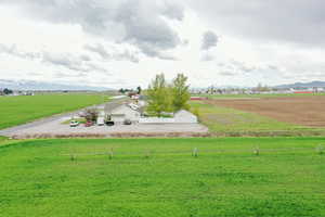 View of property's community featuring a lawn, a mountain view, and a rural view