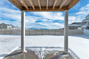 Yard covered in snow featuring a mountain view