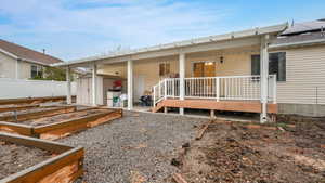 Rear view of house with a deck and a storage shed