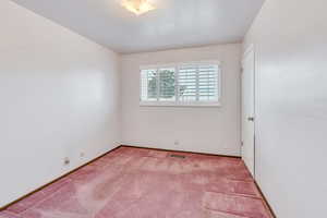 Unfurnished room featuring light colored carpet