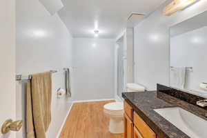 Bathroom with vanity, hardwood / wood-style flooring, toilet, and walk in shower