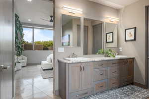 Bathroom featuring tile patterned floors, vanity, and ceiling fan