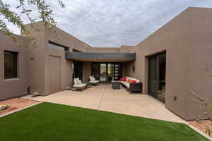 View of patio with an outdoor hangout area