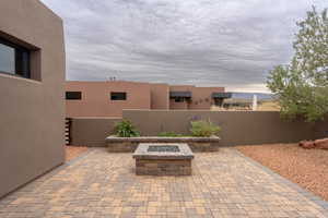 View of patio with an outdoor fire pit