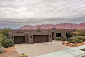 Adobe home featuring a mountain view and a garage