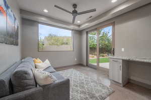 Living room with built in desk and ceiling fan