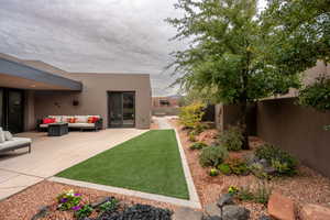 View of yard with an outdoor living space and a patio area