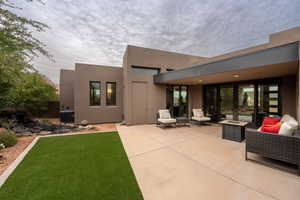 Rear view of house with outdoor lounge area, a yard, a patio, and central AC unit