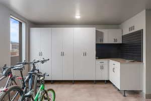 Interior space featuring decorative backsplash and white cabinets