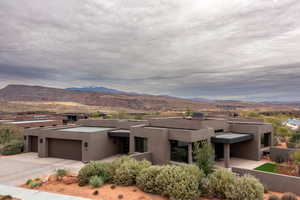 View of front of home with a mountain view and a garage