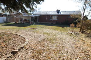 Back of property with a yard