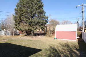 View of yard with a storage unit