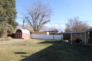 View of yard with a storage shed