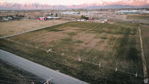 Aerial view at dusk featuring a mountain view and a rural view