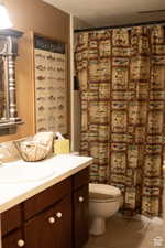 Bathroom with tile patterned floors, vanity, and toilet