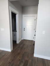 Hallway featuring dark wood-type flooring