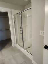 Bathroom featuring a shower with door