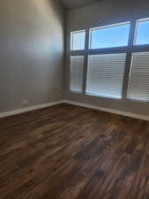 Unfurnished room featuring dark wood-type flooring