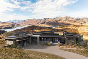 View of front of home with a water and mountain view