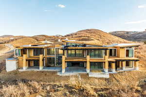 Back of property with a mountain view