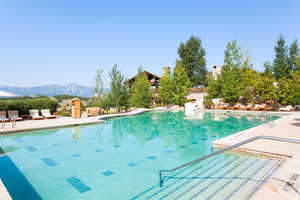 View of pool with a mountain view and a patio area