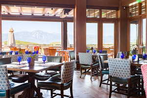 Dining area with a mountain view and wood-type flooring