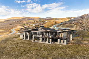 Back of property with a deck with mountain view