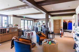 Carpeted living room featuring plenty of natural light and beam ceiling