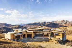 Property in mid-construction with a mountain view and a patio area