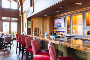 Bar featuring dark wood-type flooring and wood ceiling