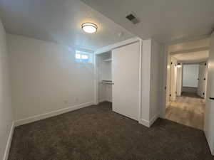 Unfurnished bedroom featuring a closet, carpet floors, and a textured ceiling