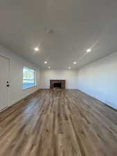 Unfurnished living room featuring light hardwood / wood-style floors and a fireplace