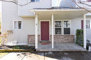 Doorway to property featuring a porch