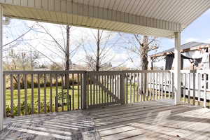 Deck featuring a lawn