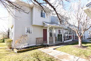 View of property with a front yard