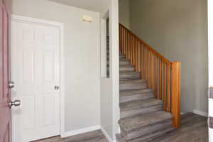 Stairway featuring wood-type flooring