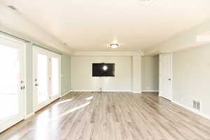 Unfurnished living room with light hardwood / wood-style floors