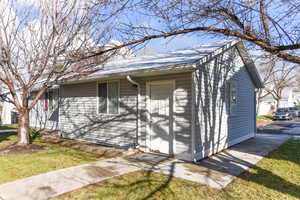 View of side of home featuring a yard