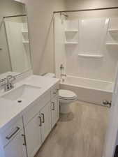 Full bathroom with vanity,  shower combination, and toilet