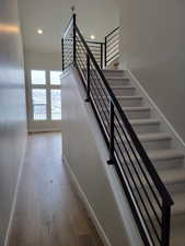 Stairway featuring hardwood / wood-style flooring