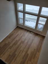 Empty room with hardwood / wood-style flooring